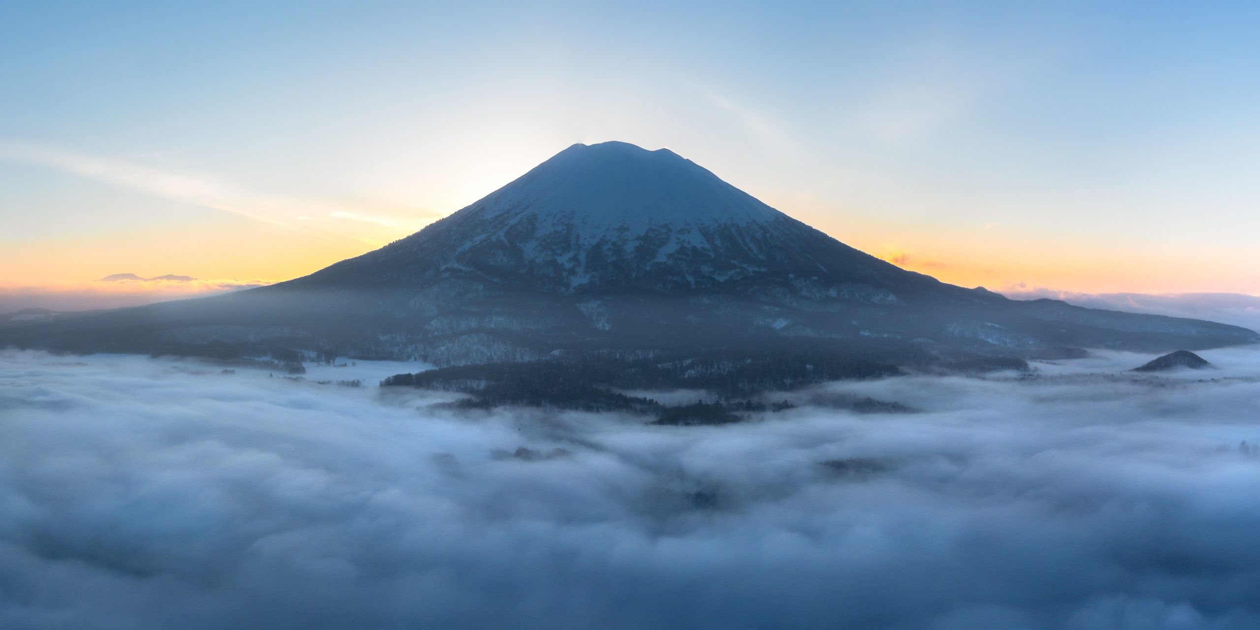 Mount Yotei rising above a sea of cloud at sunrise
