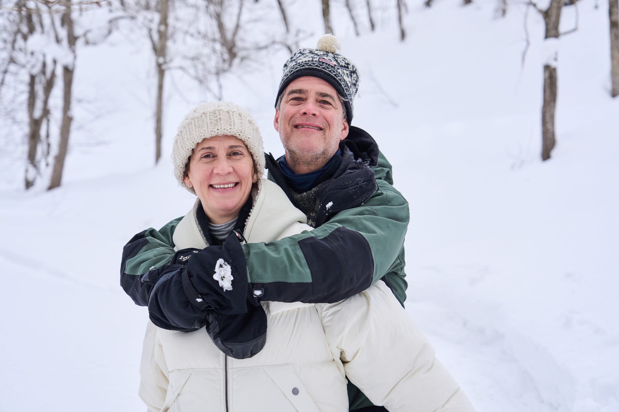 Couple embracing in the snow on the Niseko Snow Experience