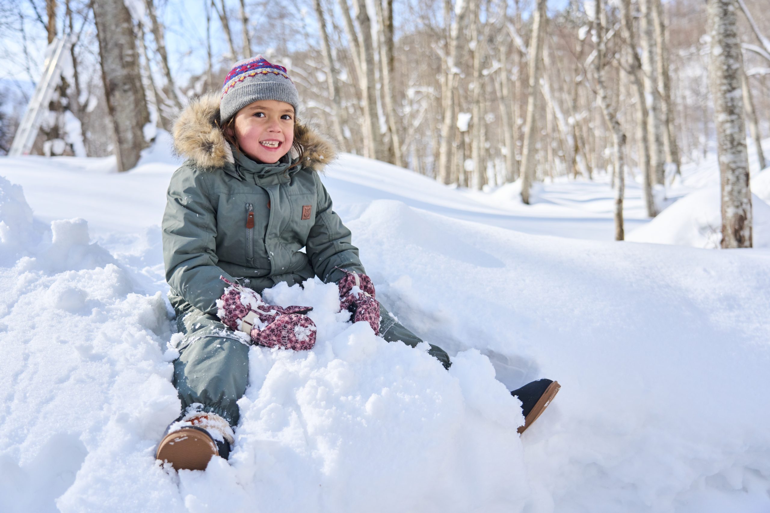 Child playing in fresh powder snow in Niseko