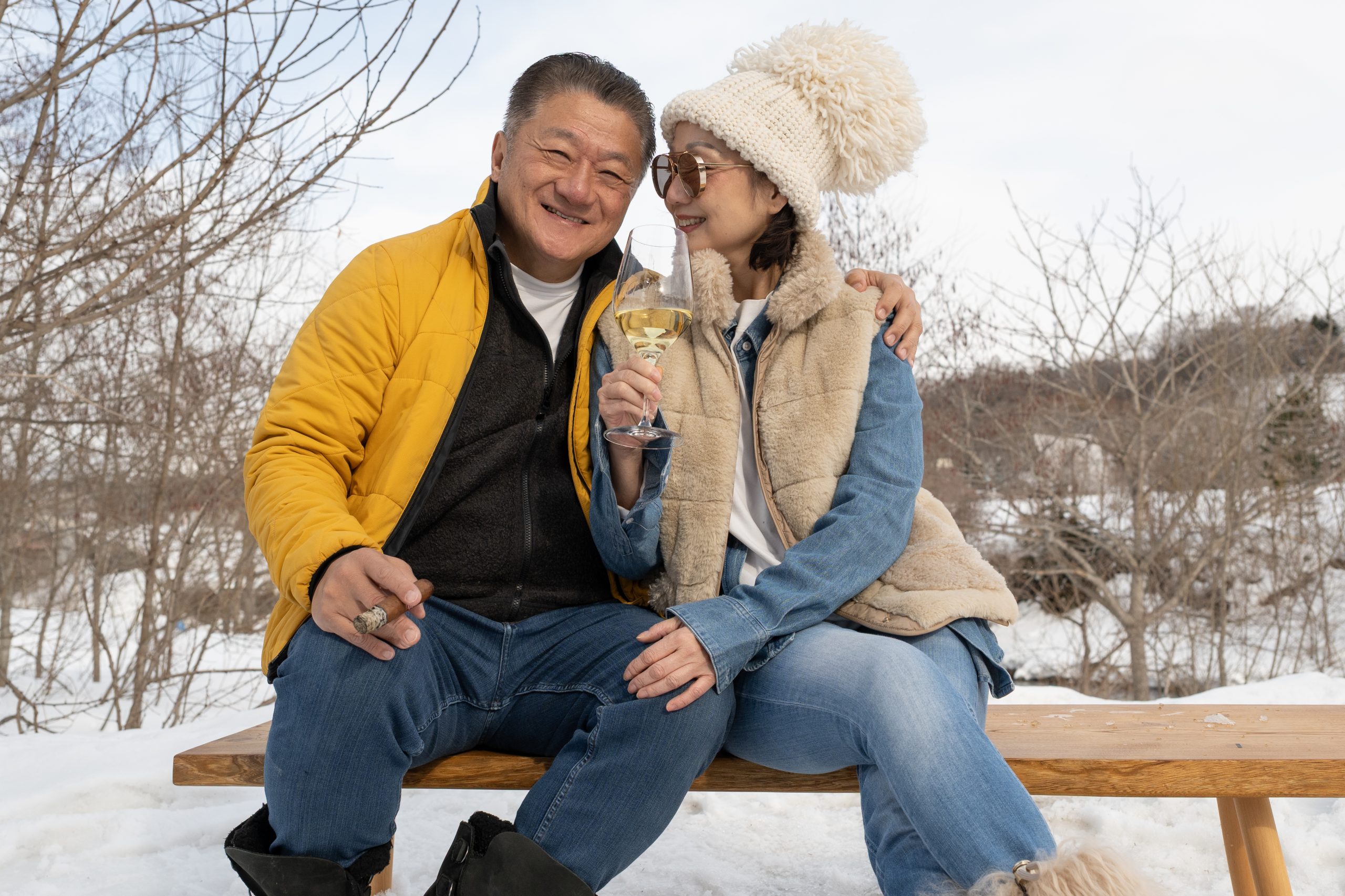 Couple sharing a laugh on a bench in the Niseko snow