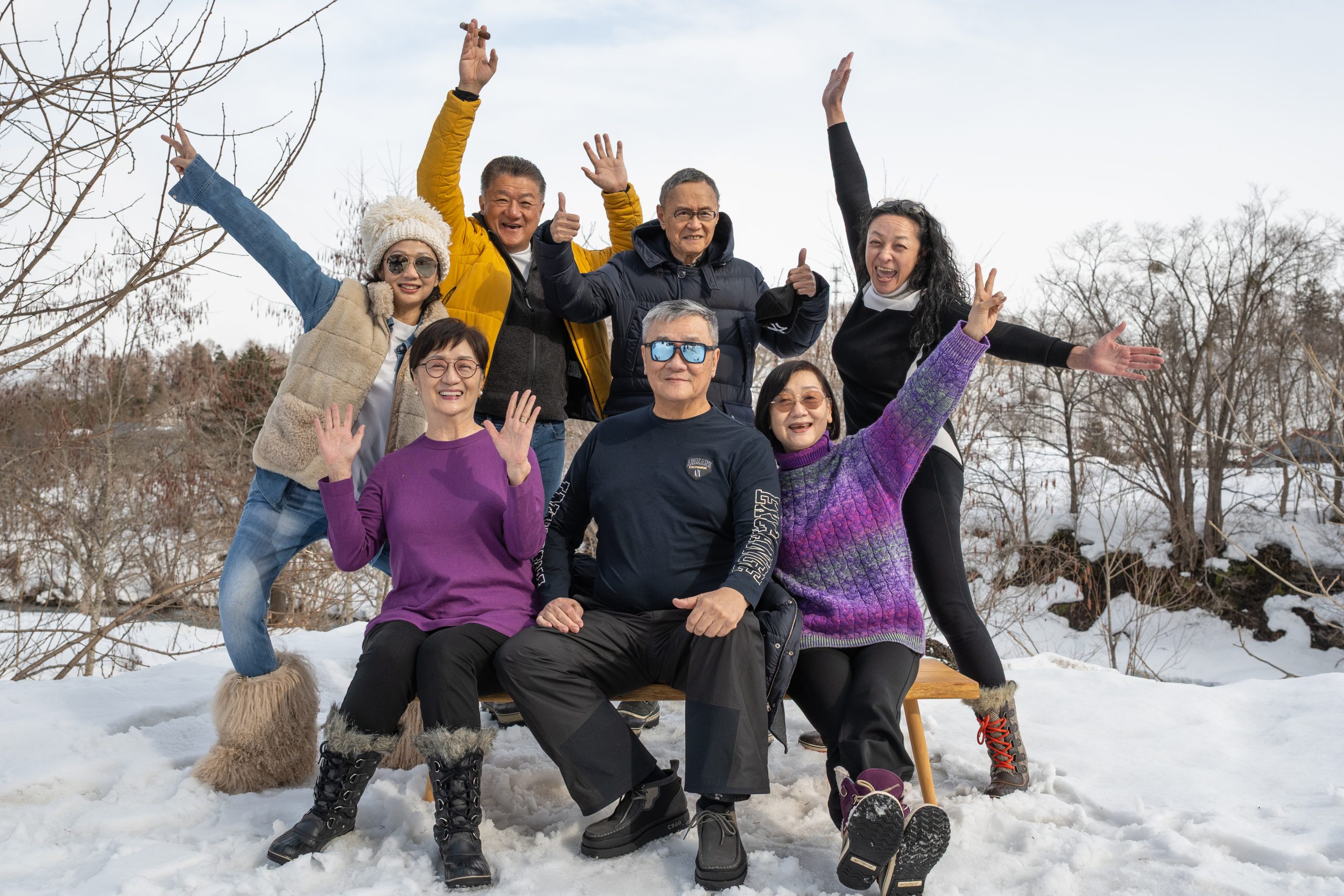 Family and friends cheering together in the snow in Niseko