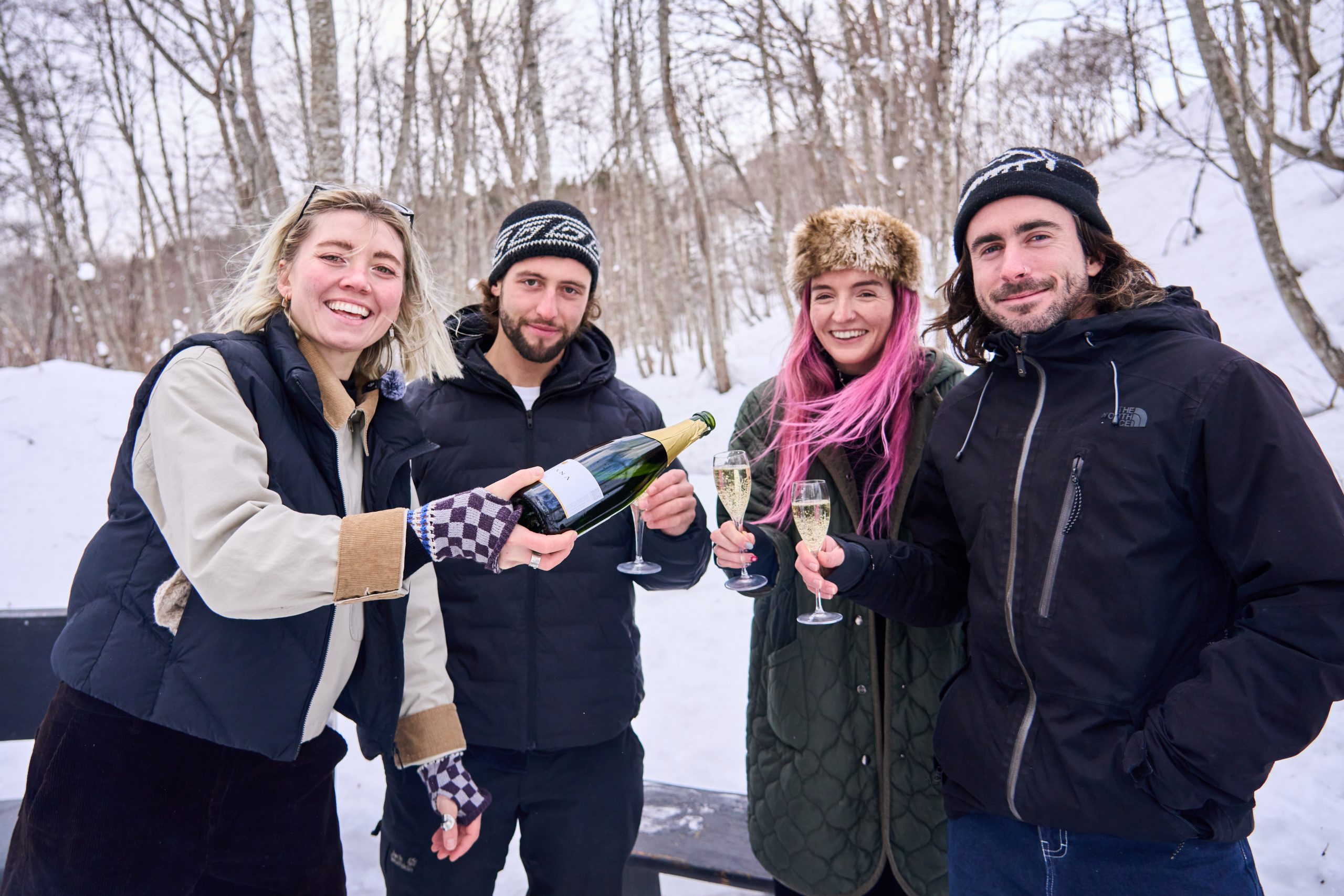 Friends sharing a toast in the snowy forest