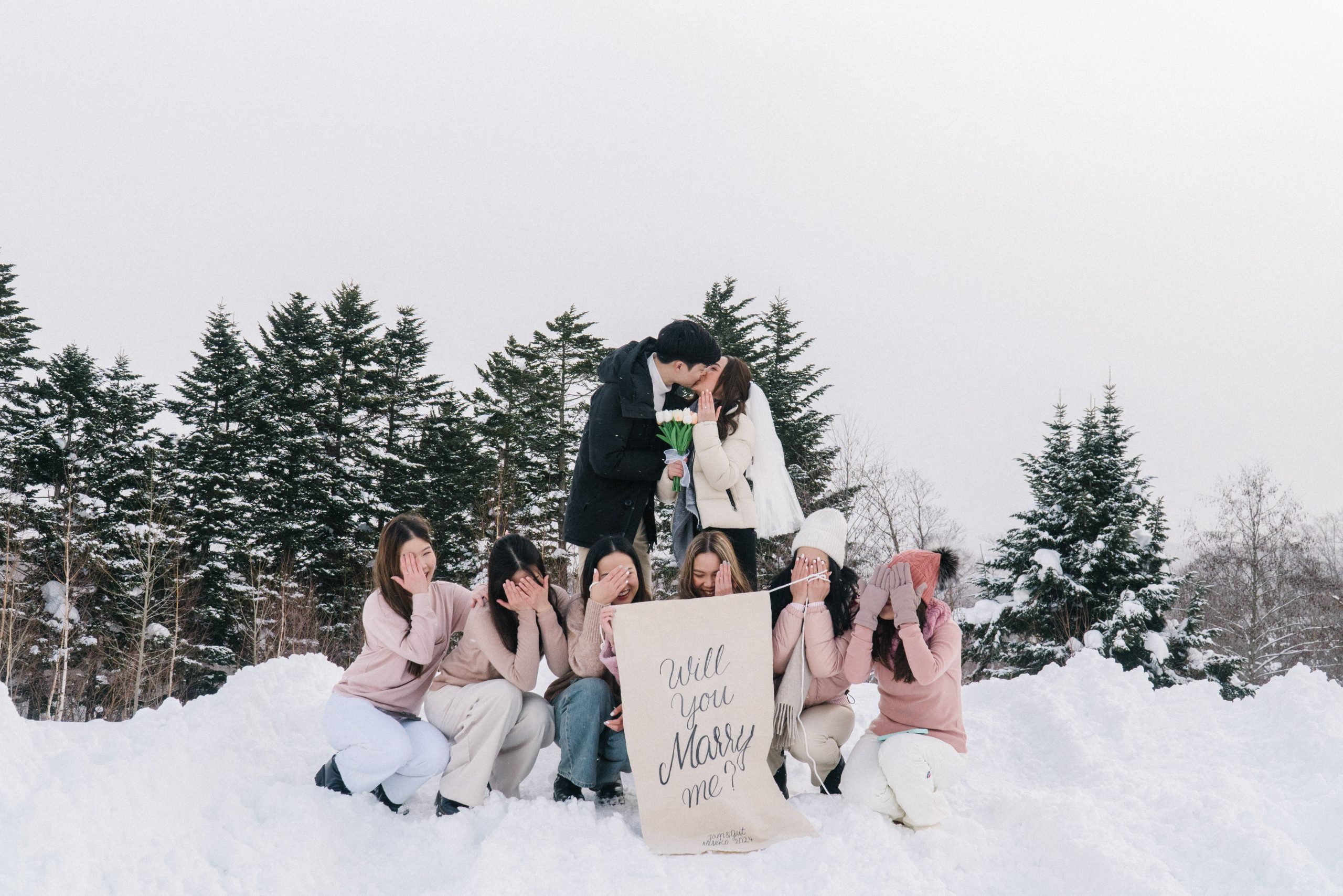 Friends gathered in the snow to celebrate a proposal in Niseko